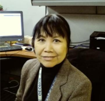 Margaret H. Jenkins smiles at the camera in a gray blazer and black shirt.