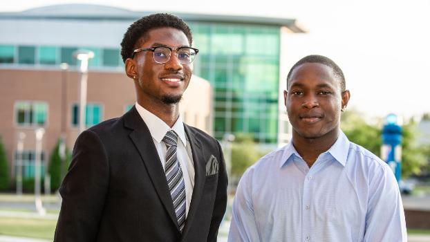 Two students smiling