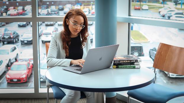 Student sitting in common area studying social sciences