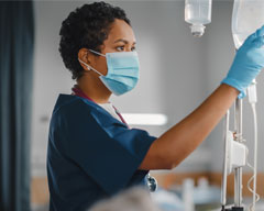 Nurse checking an IV bag