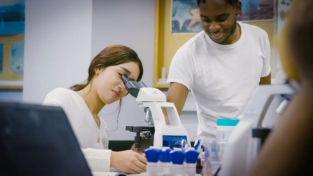 STEM student looking through a microscope