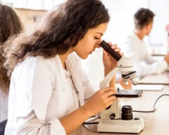 Scientist looking through a microscope