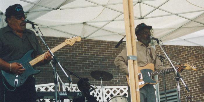 The Holmes Brothers on stage.